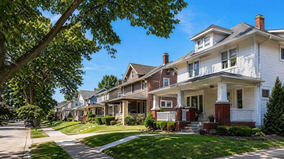 Modest Akron Ohio bungalow and colonial-style homes with mature street trees